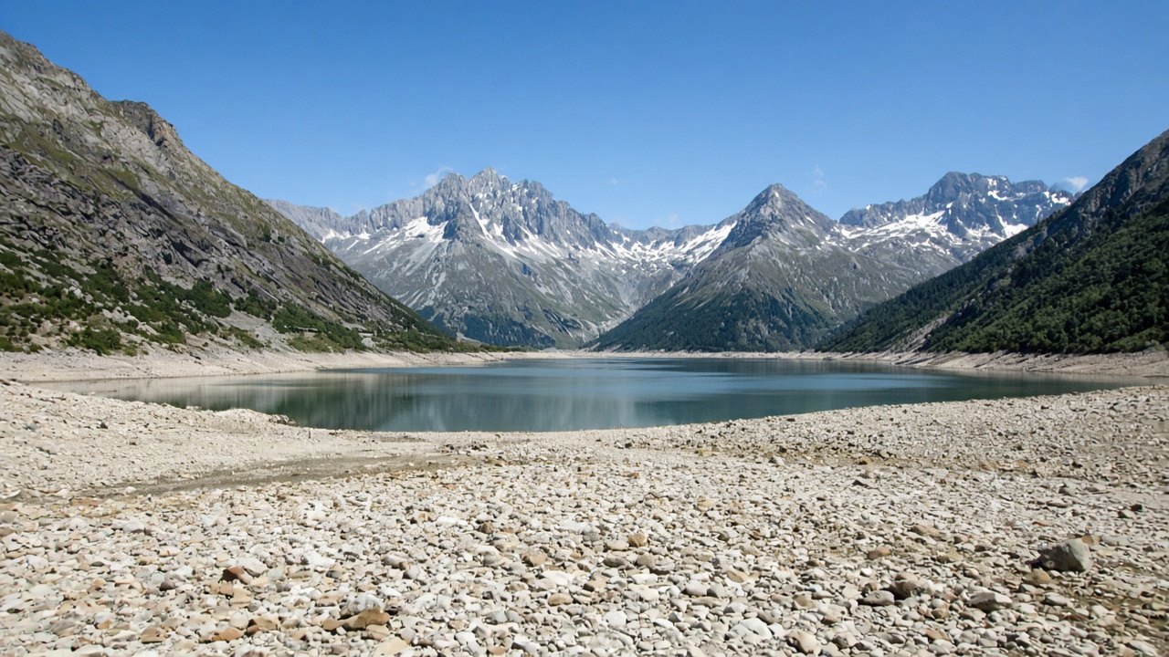 A Swiss alpine lake with a wide exposed shoreline